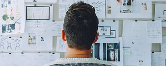 image of man looking at research board