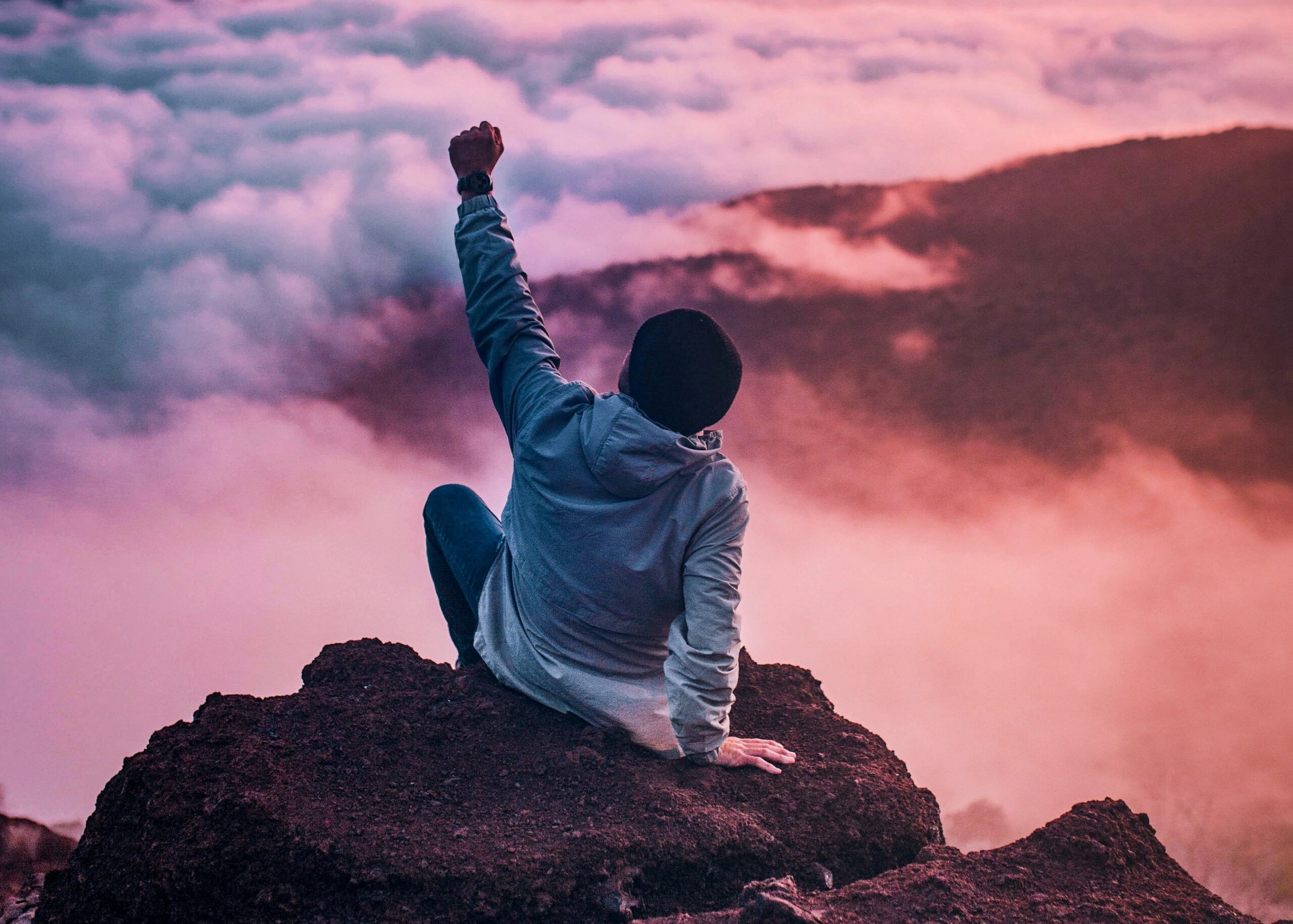 image of man reaching his goal on the top of the mountain