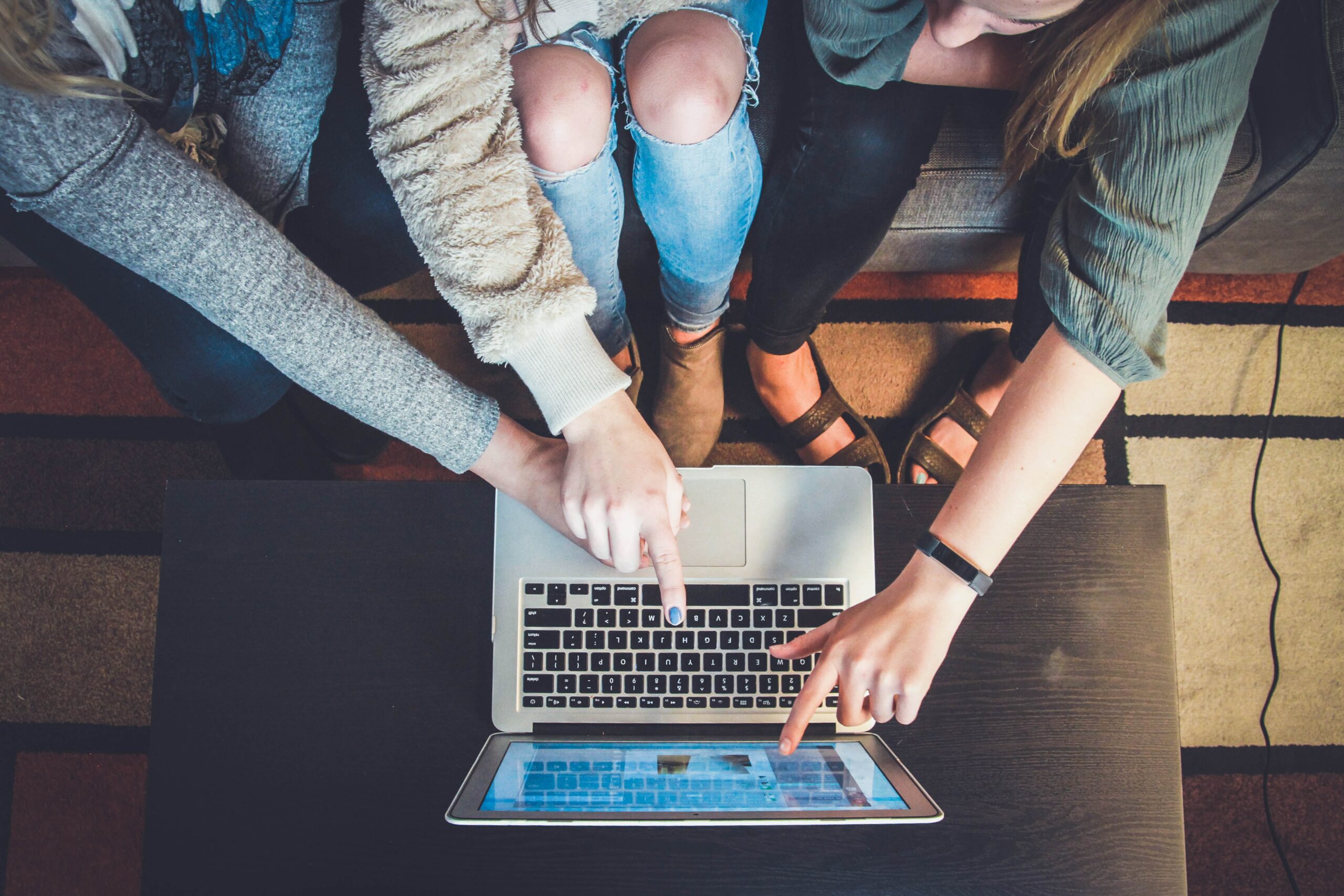 image of three people in front of a laptop